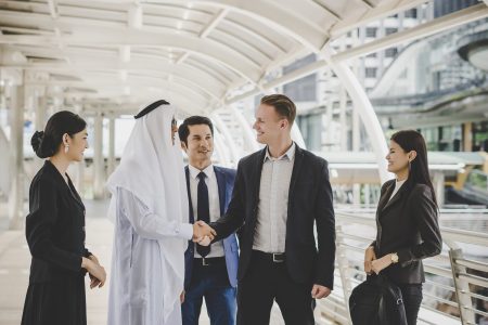 portrait-business-partners-greeting-one-another-by-handshaking-way-office-scaled.jpg